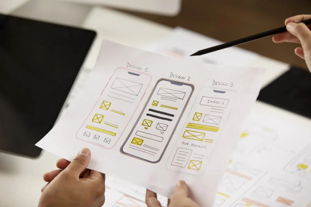 5 Top Trends in UX/UI Design to Improve Your Digital Product high angle hands holding paper Bolt Creatives 5 Top Trends in UX/UI Design to Improve Your Digital Product high angle hands holding paper Bolt Creatives
